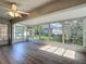 Bright sunroom with large windows offering a view of the backyard and letting in plenty of natural light at 9608 Rolling Cir, San Antonio, FL 33576