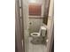 Small bathroom featuring a toilet, tile flooring, and a dark wood cabinet at 10106 Wheatley Hills Ct, Tampa, FL 33615