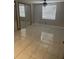 A simple bedroom boasts mirrored closet doors, tiled floors, and a ceiling fan for minimalist comfort at 10106 Wheatley Hills Ct, Tampa, FL 33615