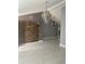 A stylish living room features stone accent wall, modern lighting, and pristine tile flooring for contemporary elegance at 10106 Wheatley Hills Ct, Tampa, FL 33615