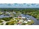Wide aerial view of home with terracotta roof in waterfront community at 105 6Th Nw St, Ruskin, FL 33570