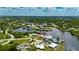 Wide aerial view showcasing home with a terracotta roof in waterfront community at 105 6Th Nw St, Ruskin, FL 33570