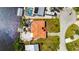 Aerial view of a home with a terracotta roof and dock with defined property lines at 105 6Th Nw St, Ruskin, FL 33570