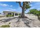 Spacious backyard featuring shell landscaping and shade trees with mature landscaping, and a red tile roof at 105 6Th Nw St, Ruskin, FL 33570