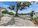 View of shell landscaping, tree, and canal behind the home with plenty of privacy at 105 6Th Nw St, Ruskin, FL 33570