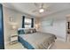 Comfortable bedroom features a large bed with a decorative ceiling fan and side tables at 105 6Th Nw St, Ruskin, FL 33570