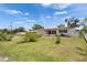 Well-maintained single-story home with a manicured lawn, lush bushes, and a charming white picket fence at 105 6Th Nw St, Ruskin, FL 33570