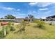 Inviting single-story home with well-kept lawn and blooming bushes under a bright, cloudy sky at 105 6Th Nw St, Ruskin, FL 33570
