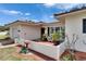 Charming home featuring a cozy, walled front porch and lovely front yard landscaping at 105 6Th Nw St, Ruskin, FL 33570