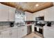 Well-lit kitchen with updated appliances, marble countertops, and a charming window view at 105 6Th Nw St, Ruskin, FL 33570