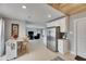 Open kitchen view showcasing stainless steel refrigerator and seamless transition to the living area at 105 6Th Nw St, Ruskin, FL 33570
