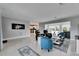 Spacious living area with Terrazzo flooring, comfy seating, and views through the sliding glass doors at 105 6Th Nw St, Ruskin, FL 33570