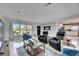 Bright living room featuring Terrazzo floors, comfortable seating, and an open layout to the kitchen at 105 6Th Nw St, Ruskin, FL 33570