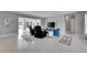 Open living room with Terrazzo floors, comfortable seating, and water views from the sliding glass doors at 105 6Th Nw St, Ruskin, FL 33570
