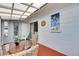 Cozy sunroom featuring nautical themed art, sliding door, and view of exterior of the home at 105 6Th Nw St, Ruskin, FL 33570