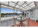 Enclosed sunroom with water view, seating, and plenty of natural light provides a relaxing atmosphere at 105 6Th Nw St, Ruskin, FL 33570