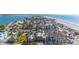 Expansive aerial view showcasing beach homes and the shimmering coastline in a vibrant seaside community at 108 14Th Ave # 2, St Pete Beach, FL 33706
