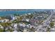 Stunning aerial highlighting a coastal community, with houses surrounded by water and palm trees at 108 14Th Ave # 2, St Pete Beach, FL 33706