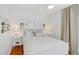 Bright bedroom with white furniture, modern decor, and hardwood floors at 108 14Th Ave # 2, St Pete Beach, FL 33706