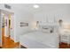 Bright bedroom featuring hardwood floors, fresh white walls, nautical decor, and neutral-toned accents at 108 14Th Ave # 2, St Pete Beach, FL 33706