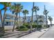 Elegant multi-story homes with balconies, surrounded by tropical foliage and a well-maintained sidewalk at 108 14Th Ave # 2, St Pete Beach, FL 33706