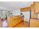 Open kitchen with stainless steel appliances and a bar area overlooking the living area at 108 14Th Ave # 2, St Pete Beach, FL 33706