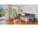 Bright living room with hardwood floors, large window, and comfortable seating area at 108 14Th Ave # 2, St Pete Beach, FL 33706