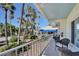 Enjoy the outdoors on the covered porch featuring a seating area and scenic views of palm trees at 108 14Th Ave # 2, St Pete Beach, FL 33706
