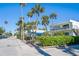 Picturesque street featuring homes with lush tropical landscaping, enhancing the property's curb appeal at 108 14Th Ave # 2, St Pete Beach, FL 33706