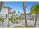Scenic street view with palm trees framing the road, leading to a beachside community by the ocean at 108 14Th Ave # 2, St Pete Beach, FL 33706