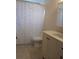 Cozy bathroom featuring a vanity, speckled shower curtain, toilet and tile floors at 10968 105Th Ave, Largo, FL 33778