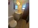 This bathroom features a toilet, vanity, sink, mirror, and a window for natural light at 10968 105Th Ave, Largo, FL 33778