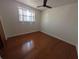 This empty bedroom has hardwood floors, neutral paint, and a ceiling fan at 10968 105Th Ave, Largo, FL 33778