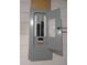 Image shows a gray electrical panel mounted on a block wall with open door revealing circuit breakers and an electrical map at 10968 105Th Ave, Largo, FL 33778