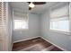 Cozy bedroom features two windows, ceiling fan and wood-look laminate flooring at 11 Lafayette St, Bradenton, FL 34208