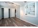 Bedroom with wood-look floors, closet, and a niche bookshelf to display art at 11 Lafayette St, Bradenton, FL 34208