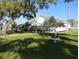 Charming cottage featuring a covered porch, beautiful landscaping, and a peaceful setting at 11 Lafayette St, Bradenton, FL 34208