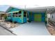 Blue and green house with white carport and a cheerful exterior design, enhancing the home's curb appeal at 11 Lafayette St, Bradenton, FL 34208