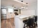 Modern kitchen featuring stainless steel appliances, white marble countertops, and breakfast bar seating at 11 Lafayette St, Bradenton, FL 34208