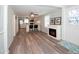 Open floor plan showcasing the new flooring, electric fireplace and view into the kitchen at 11 Lafayette St, Bradenton, FL 34208