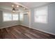 Bright room with wood-look flooring, an AC unit, and three windows with blinds at 11 Lafayette St, Bradenton, FL 34208