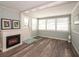 Bright living room featuring new floors, fireplace, and lots of windows allowing for ample natural light at 11 Lafayette St, Bradenton, FL 34208