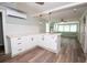 Open living area with wood-look flooring, bright lighting, and white cabinets at 11 Lafayette St, Bradenton, FL 34208