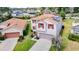 Aerial view of a home with solar panels, a separate garage, and well-kept landscaping at 1105 Canyon Oaks Dr, Brandon, FL 33510