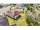 An aerial view of the house highlighting a large backyard, a covered patio, solar panels, and mature landscaping at 1105 Canyon Oaks Dr, Brandon, FL 33510