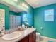 Well-lit bathroom with a sink vanity, toilet, and decorative mirror at 1105 Canyon Oaks Dr, Brandon, FL 33510