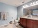 Bathroom showcasing a double sink vanity, toilet, and neutral-toned walls at 1105 Canyon Oaks Dr, Brandon, FL 33510