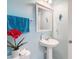 Stylish half bathroom features blue walls, a modern sink, a framed mirror, and elegant decorations at 1105 Canyon Oaks Dr, Brandon, FL 33510