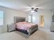 Bedroom with a modern bed frame, ceiling fan, and an en suite bathroom at 1105 Canyon Oaks Dr, Brandon, FL 33510