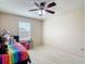 Bright bedroom featuring a ceiling fan and a window, with carpeted floors and neutral colored walls at 1105 Canyon Oaks Dr, Brandon, FL 33510